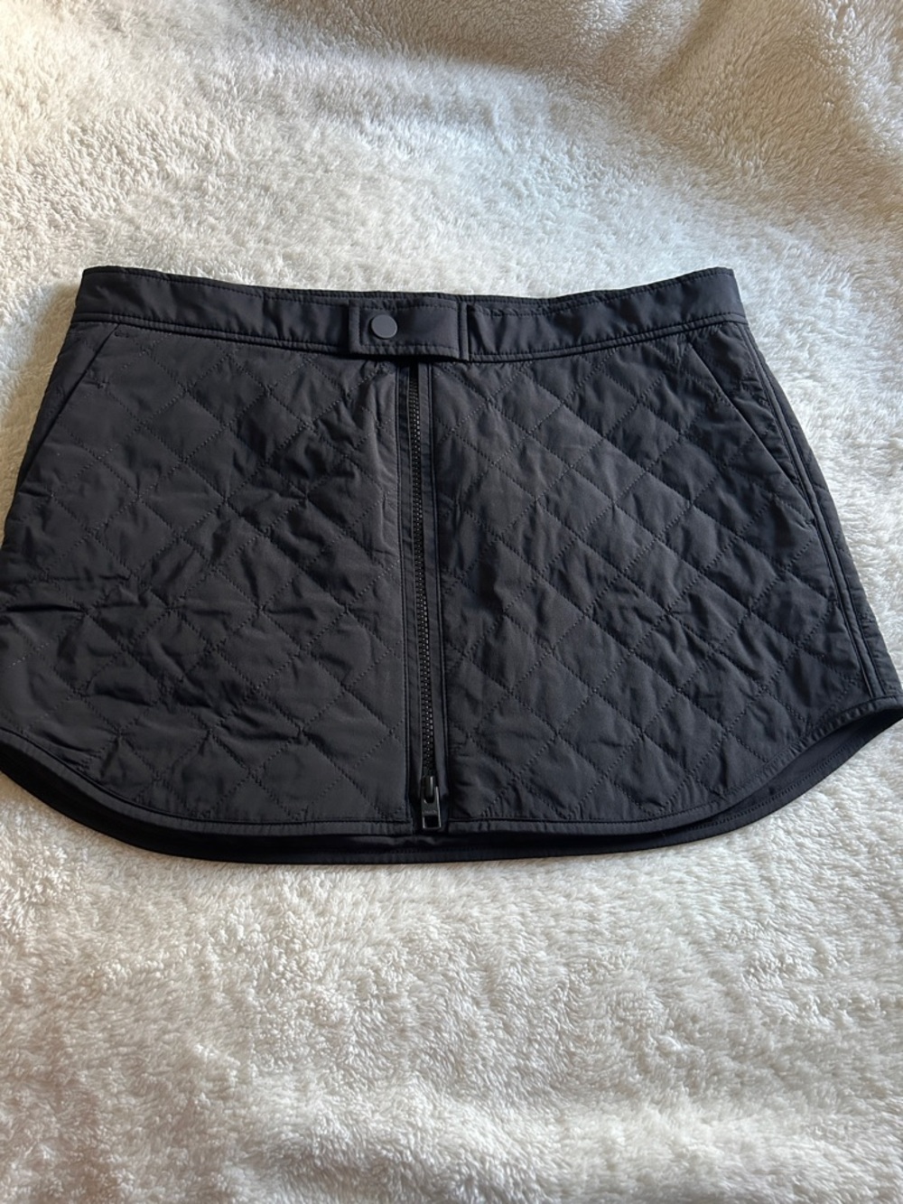 Athleta Toasty Buns Quilted Insulated Skirt in black.